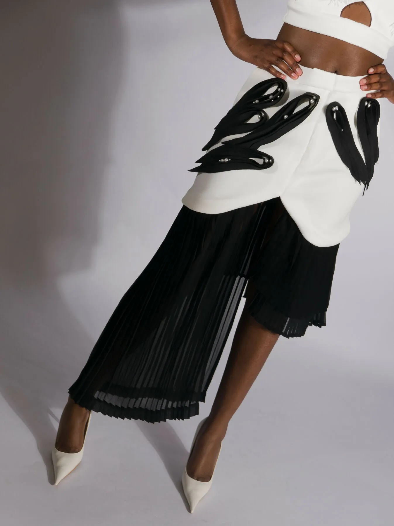 ARGO, asymmetrical pleated skirt with neoprene quilling-like application